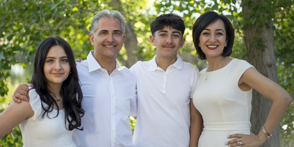 Dr. Al Rezaei with his wife and children, posing together as a family